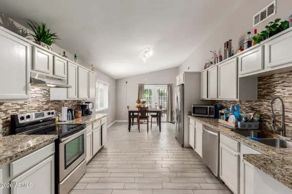 a kitchen with lots of counter top space and appliances