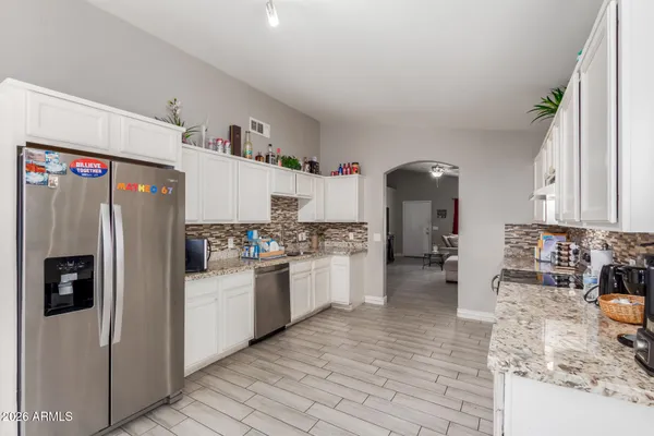 a kitchen with refrigerator and cabinets