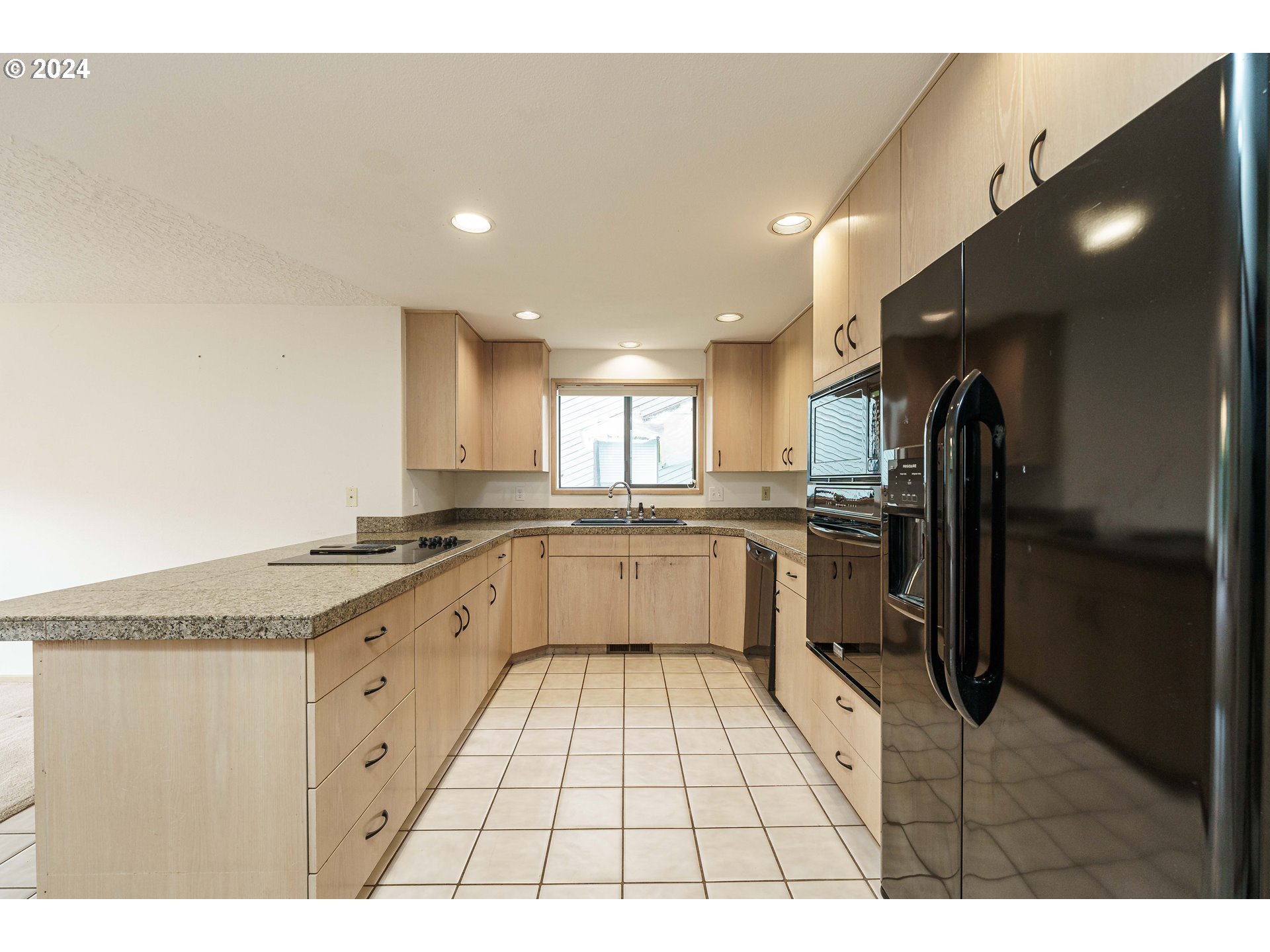 3300 Northeast 164th Street, Unit K2 Ridgefield, WA 98642 - Photo 11 of 40 a large kitchen with granite countertop a sink and cabinets