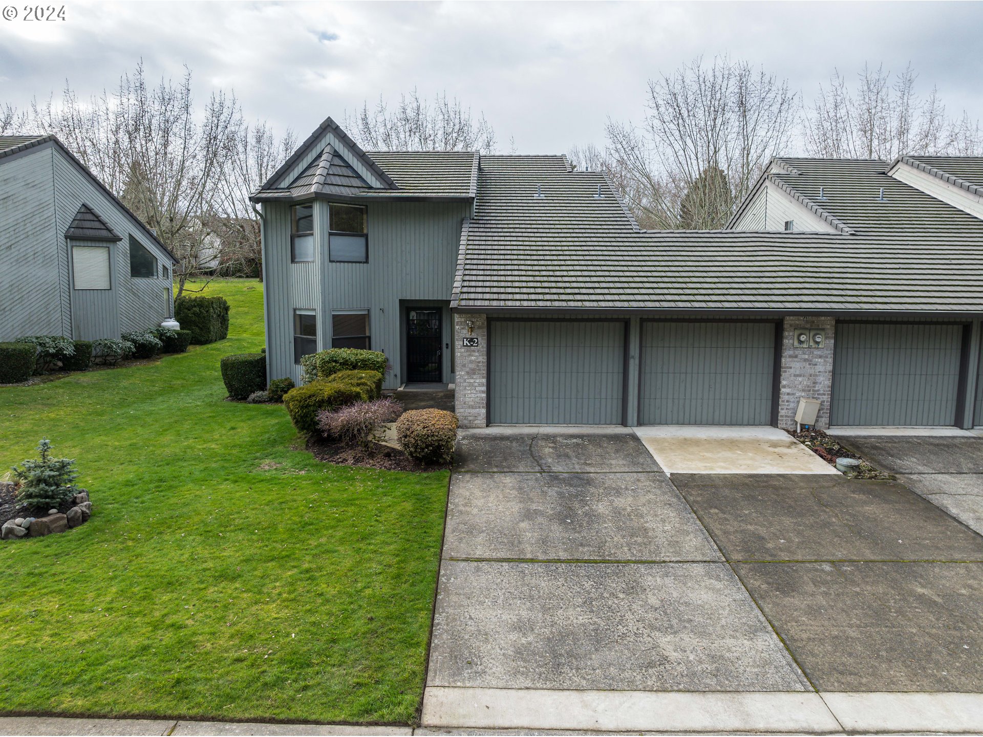 3300 Northeast 164th Street, Unit K2 Ridgefield, WA 98642 - Photo 2 of 40 a front view of a house with garden