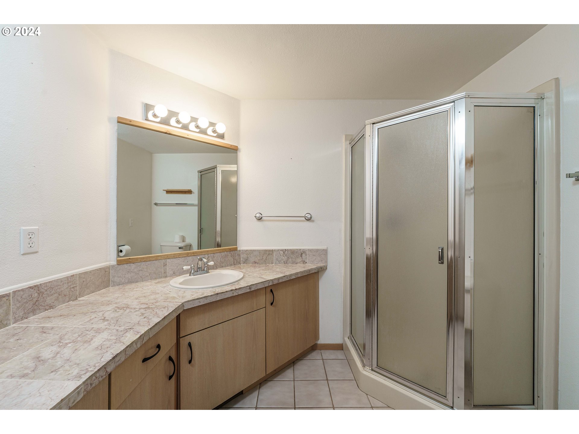 3300 Northeast 164th Street, Unit K2 Ridgefield, WA 98642 - Photo 8 of 40 a bathroom with a granite countertop sink mirror and double