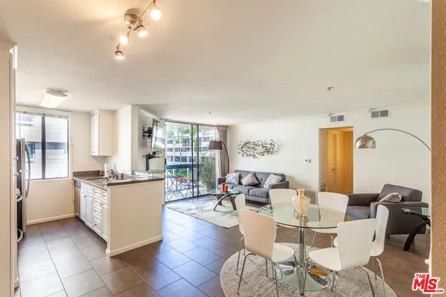 a living room with fireplace furniture and a table