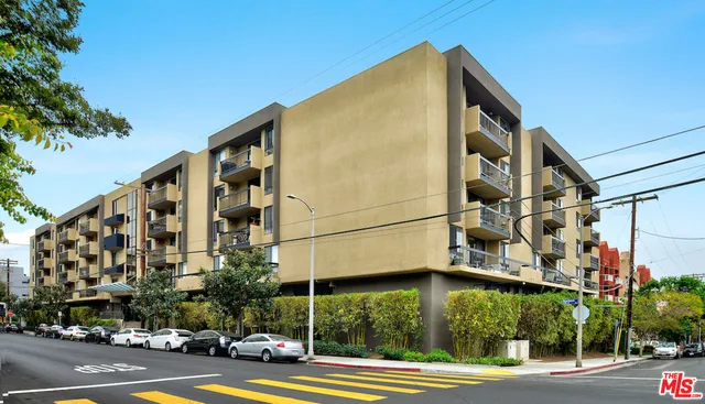 a view of a tall building next to a road
