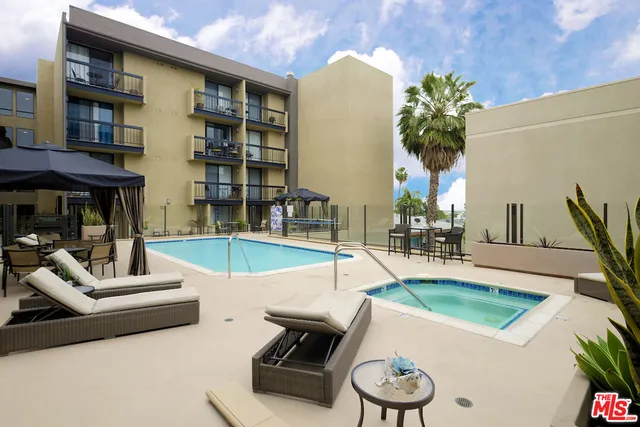 a view of a backyard with plants and swimming pool