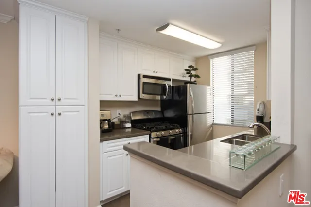a kitchen with a refrigerator stove and microwave