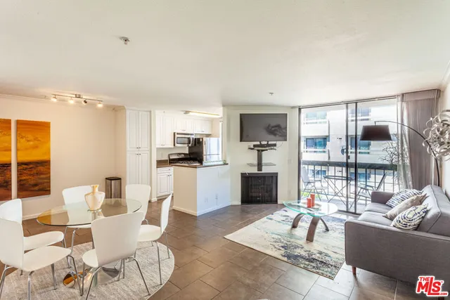 a living room with furniture and kitchen view