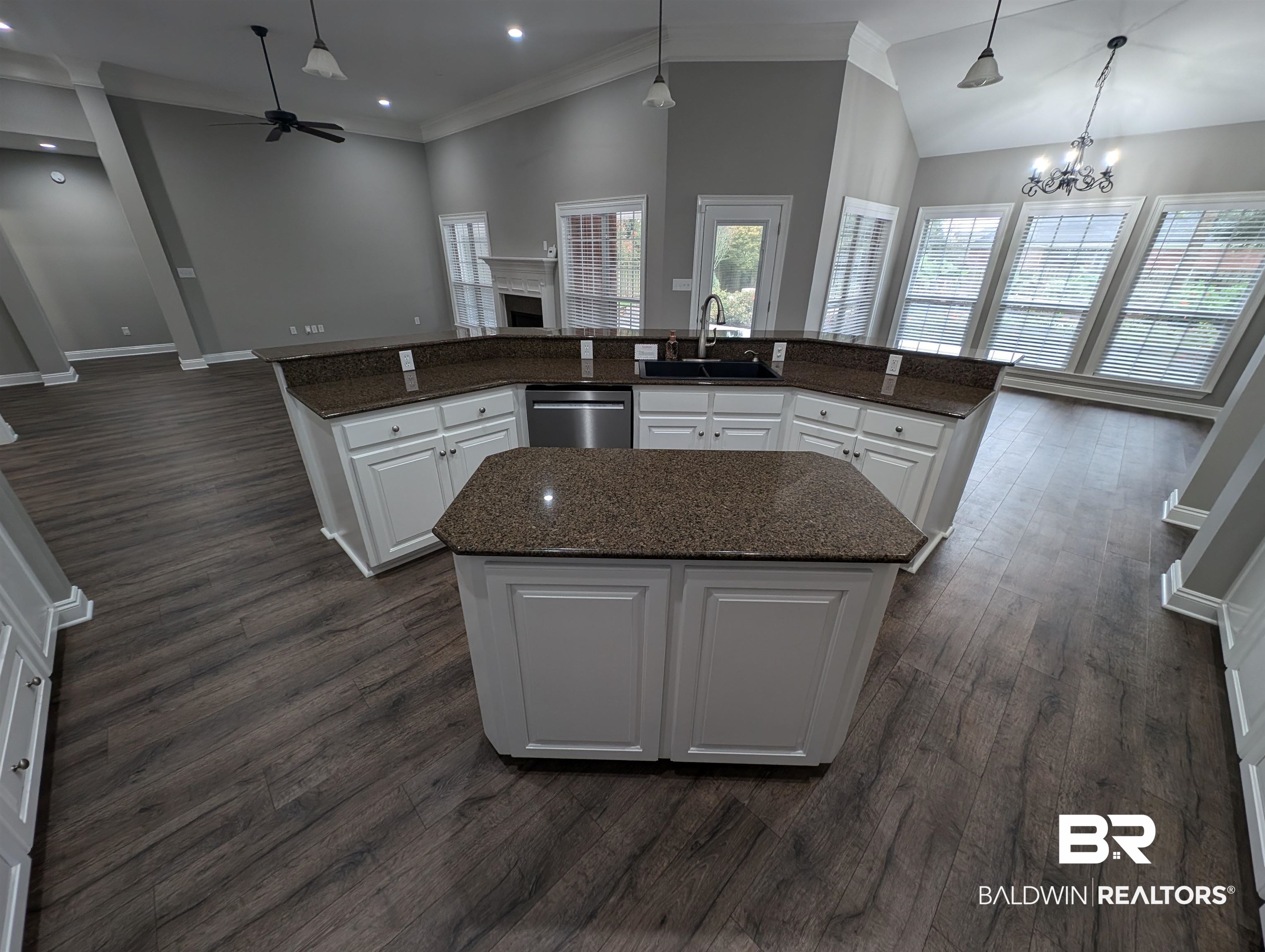 11623 Halcyon Loop Daphne, AL 36526 - Photo 25 of 90 Kitchen featuring decorative light fixtures, ceiling fan with notable chandelier, sink, and a center island, breakfast bar, overlooking open living space