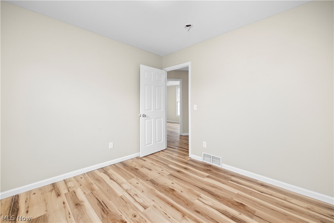 12452 Island Road Grafton, OH 44044 - Photo 25 of 39 Unfurnished room with light wood-type flooring and baseboards