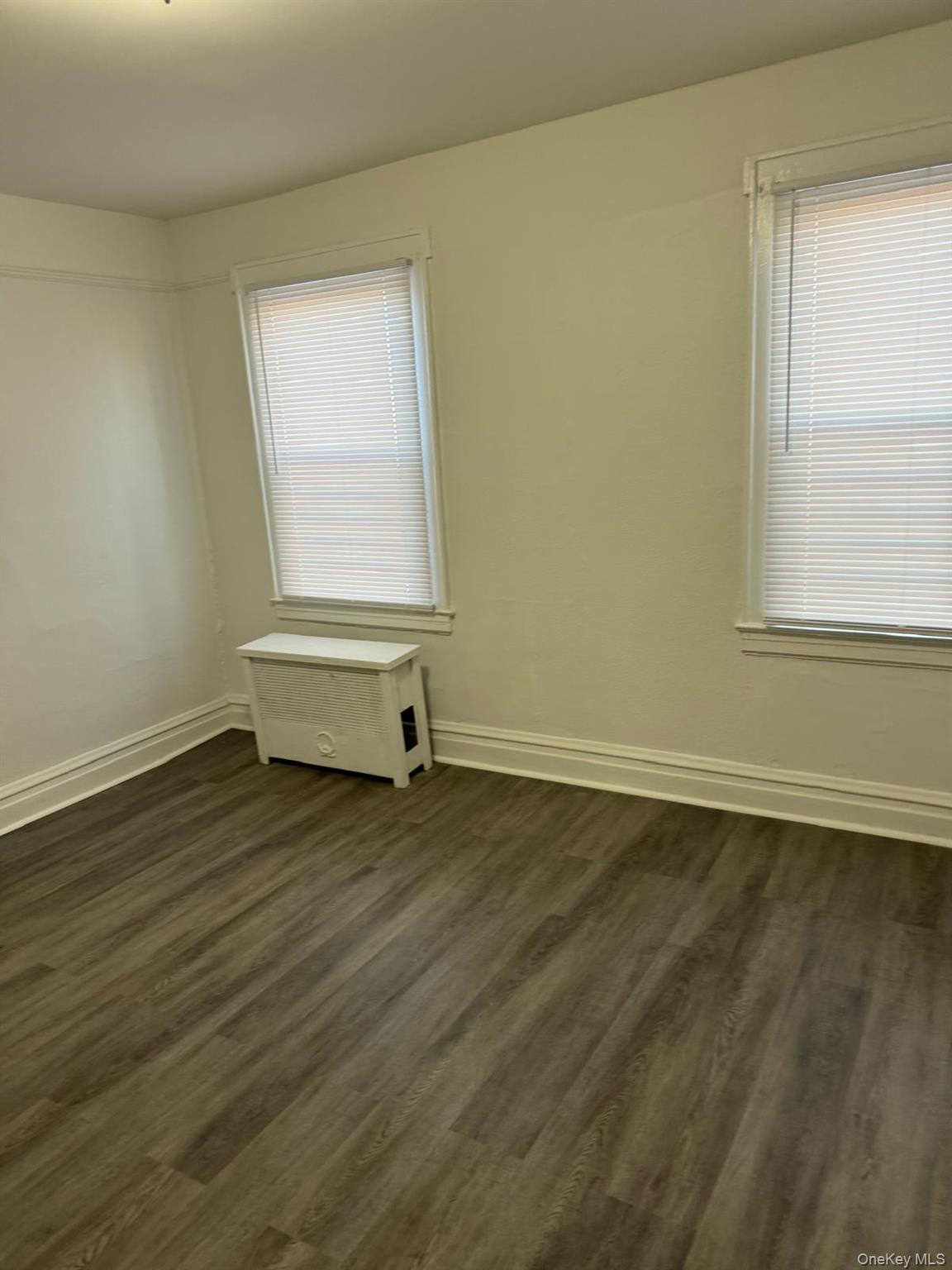 114-25 201st Street Queens, NY 11412 - Photo 12 of 18 Unfurnished room featuring baseboards and dark wood-type flooring