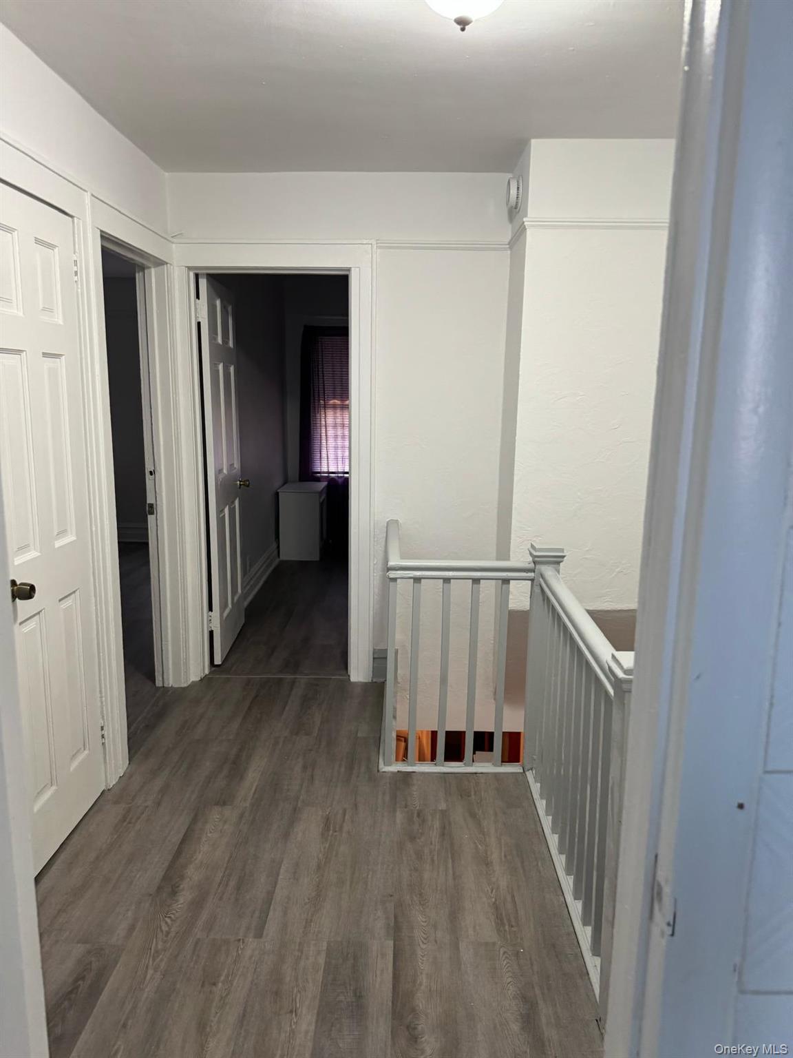 114-25 201st Street Queens, NY 11412 - Photo 14 of 18 Corridor featuring an upstairs landing and dark wood-style flooring