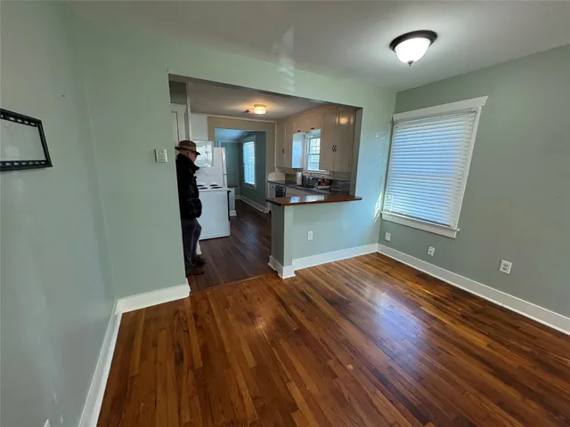 a kitchen with wooden floor and a sink