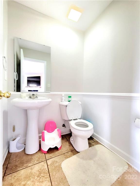 4724 Meadowfield Road Charlotte, NC 28215 - Photo 12 of 29 a bathroom with a sink toilet and mirror