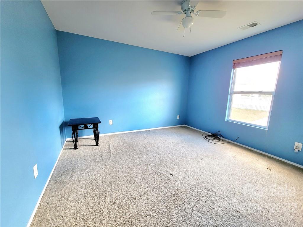 4724 Meadowfield Road Charlotte, NC 28215 - Photo 18 of 29 an empty room with a window and a ceiling fan