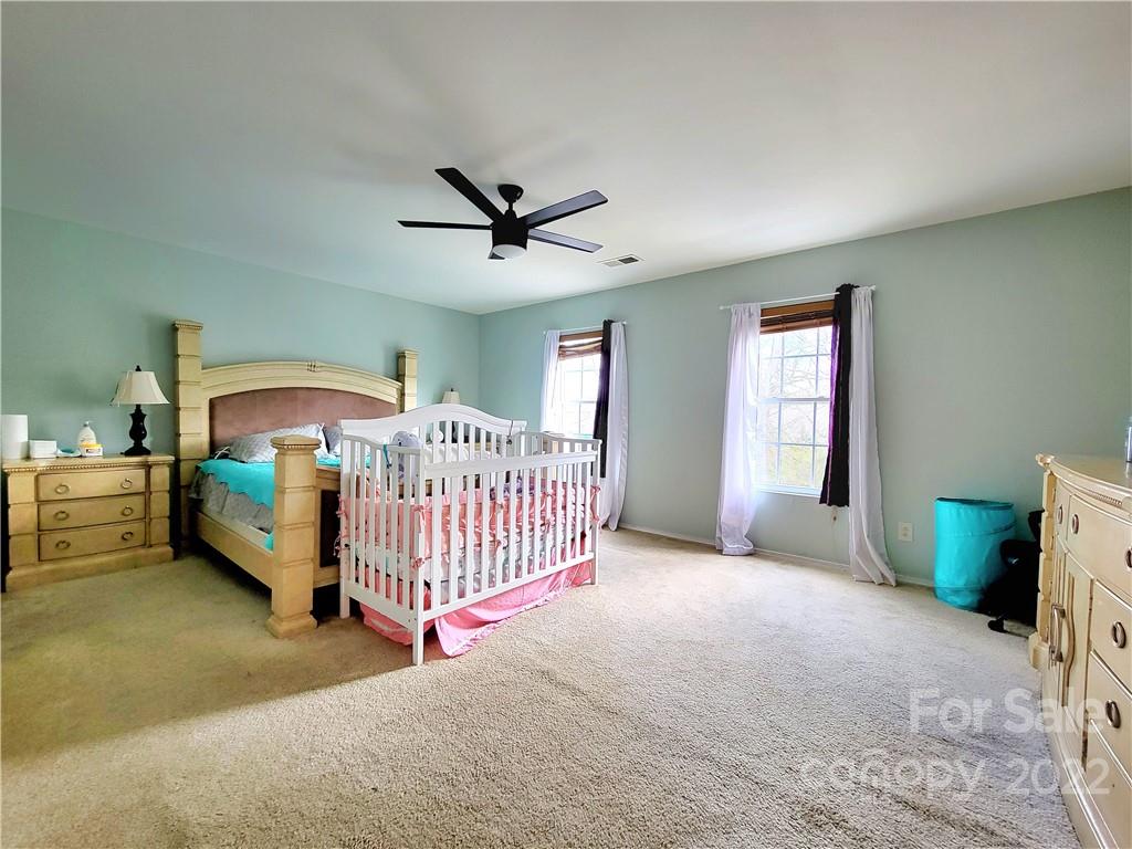 4724 Meadowfield Road Charlotte, NC 28215 - Photo 22 of 29 a view of a livingroom with a ceiling fan and a window