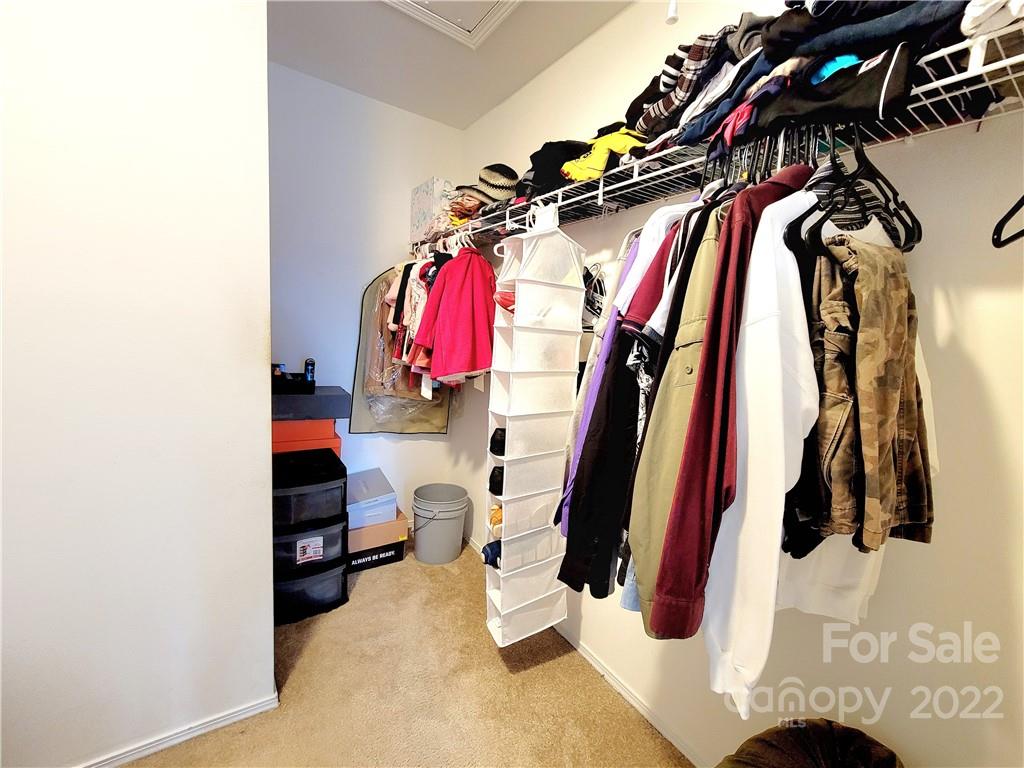 4724 Meadowfield Road Charlotte, NC 28215 - Photo 23 of 29 a view of walk in closet with clothes and shoes