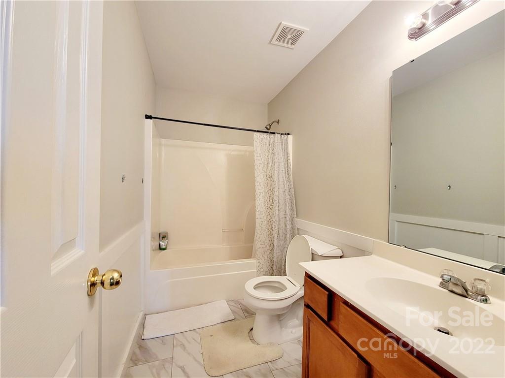 4724 Meadowfield Road Charlotte, NC 28215 - Photo 24 of 29 a bathroom with a sink a toilet and shower