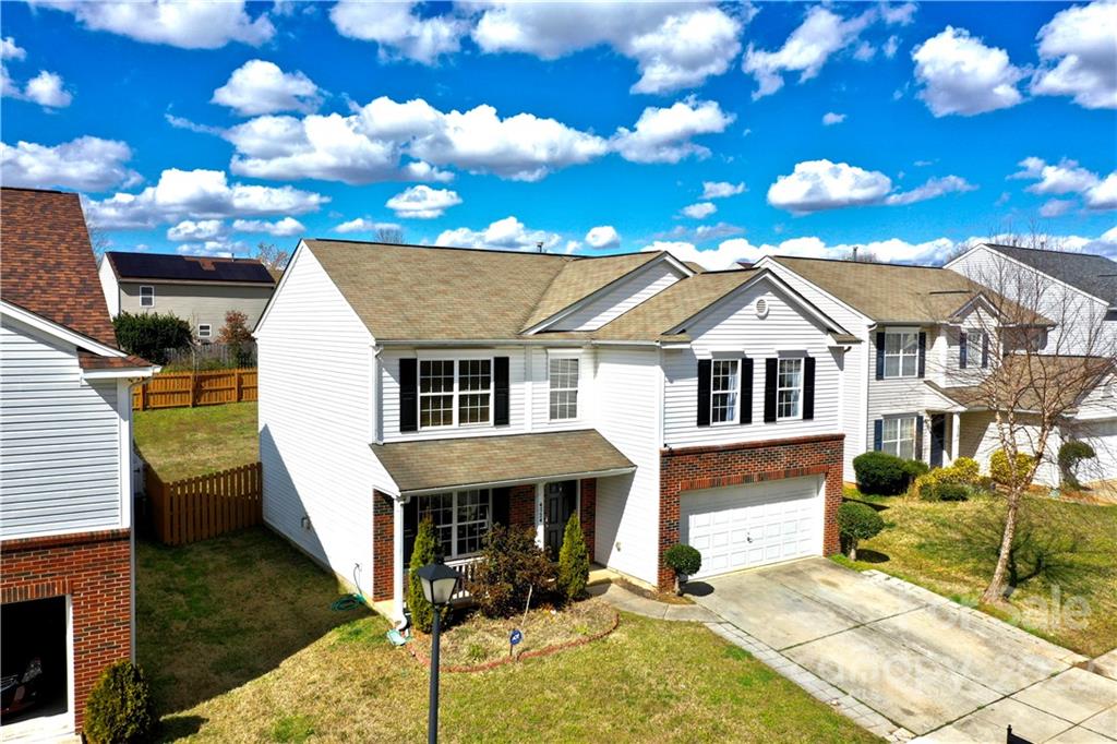 4724 Meadowfield Road Charlotte, NC 28215 - Photo 3 of 29 a view of a white house with a patio next to a yard