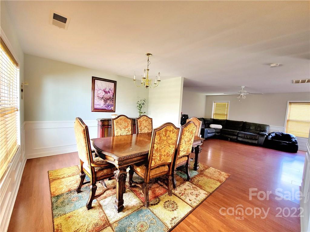 4724 Meadowfield Road Charlotte, NC 28215 - Photo 9 of 29 a view of a dining room with furniture and wooden floor