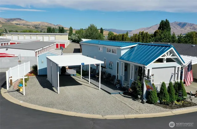 an aerial view of a house with a yard and potted plants