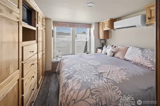 a spacious bedroom with a bed and a window