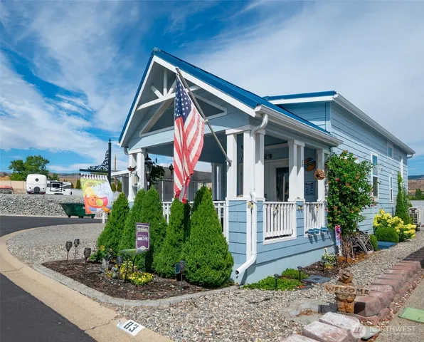 a front view of house with a yard and potted plants