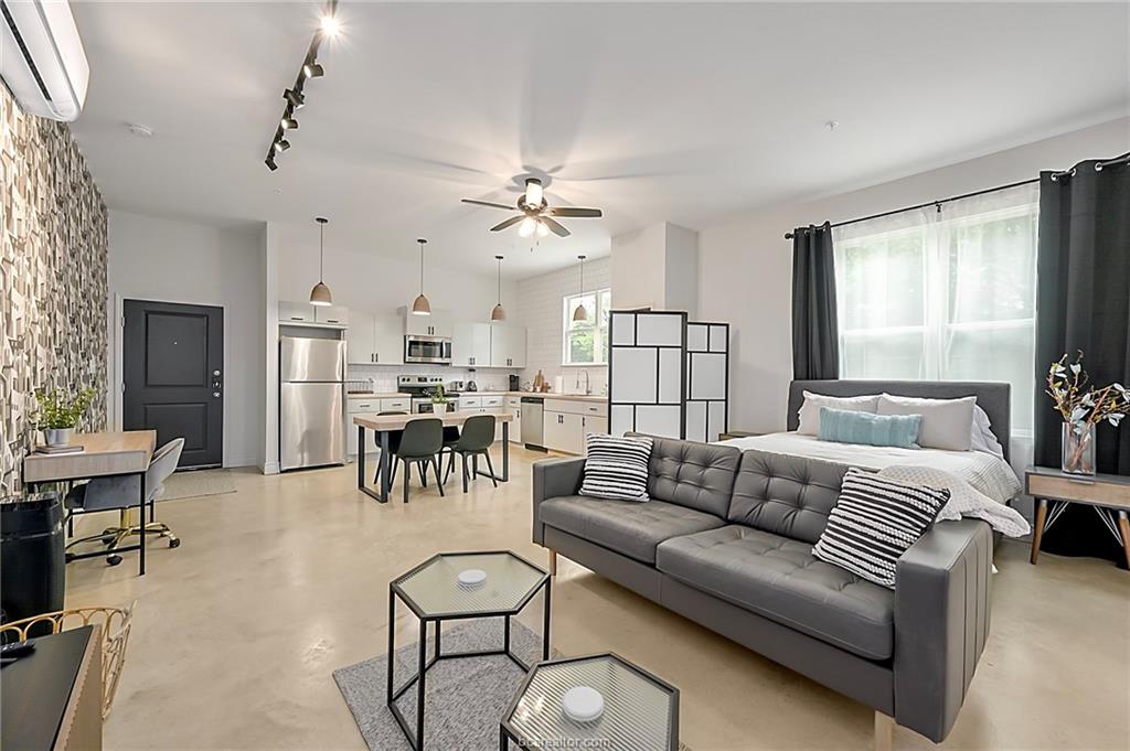 603 South Sims Avenue, Unit 113 Bryan, TX 77803 - Photo 3 of 10 a living room with furniture kitchen view and a chandelier