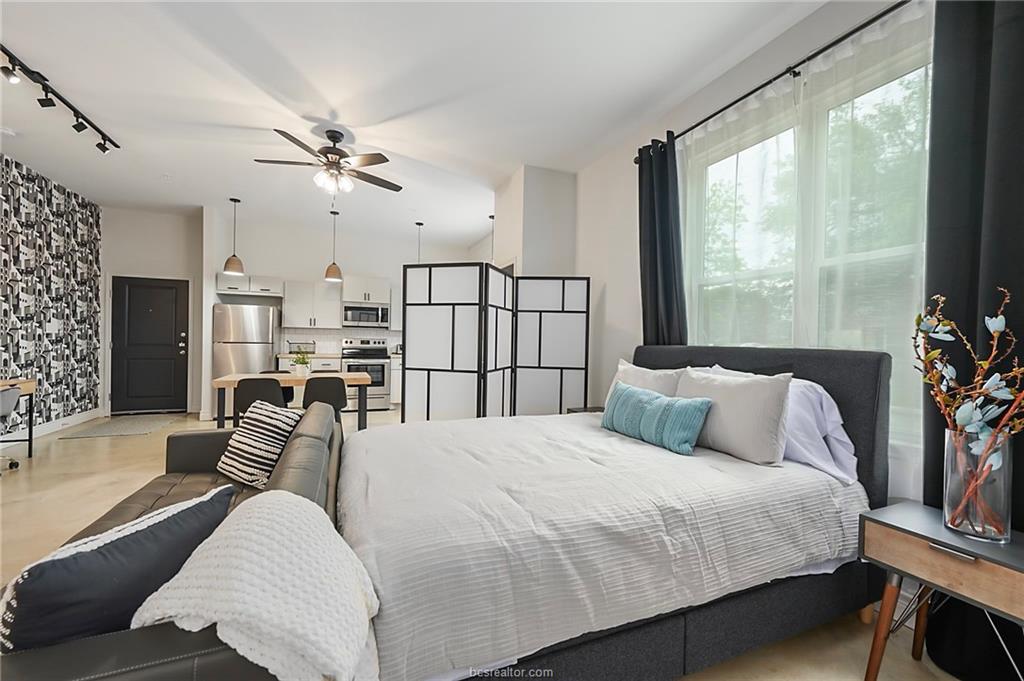 603 South Sims Avenue, Unit 113 Bryan, TX 77803 - Photo 8 of 10 a bedroom with a large bed and a large window