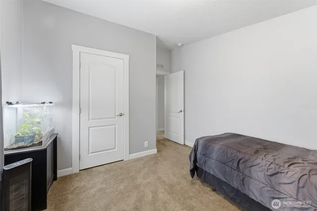 a bedroom with a bed and a potted plant