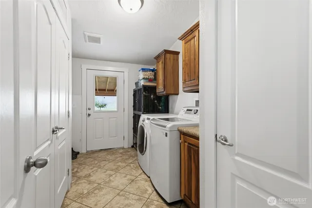 a view of a kitchen with a sink washer and dryer