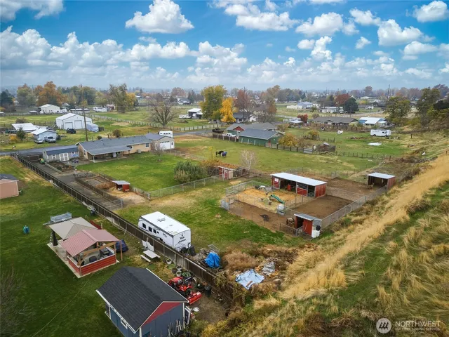 an aerial view of residential houses with outdoor space and swimming pool