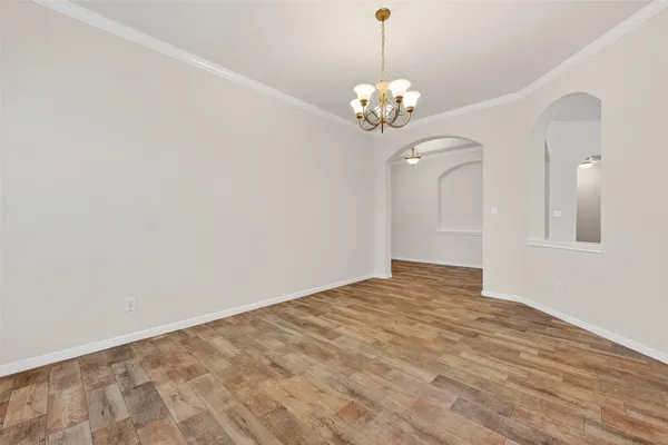 a view of an empty room with a chandelier