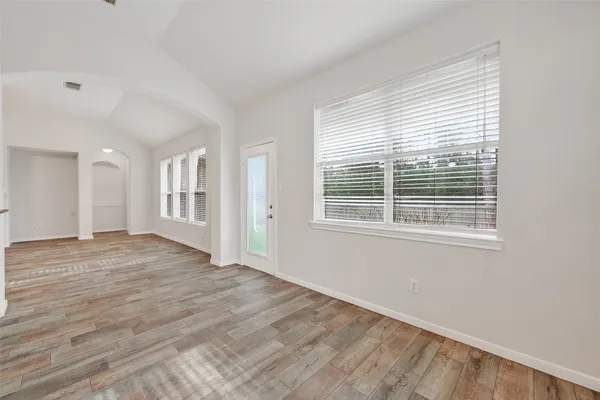 a kitchen with stainless steel appliances granite countertop white cabinets and a stove top oven