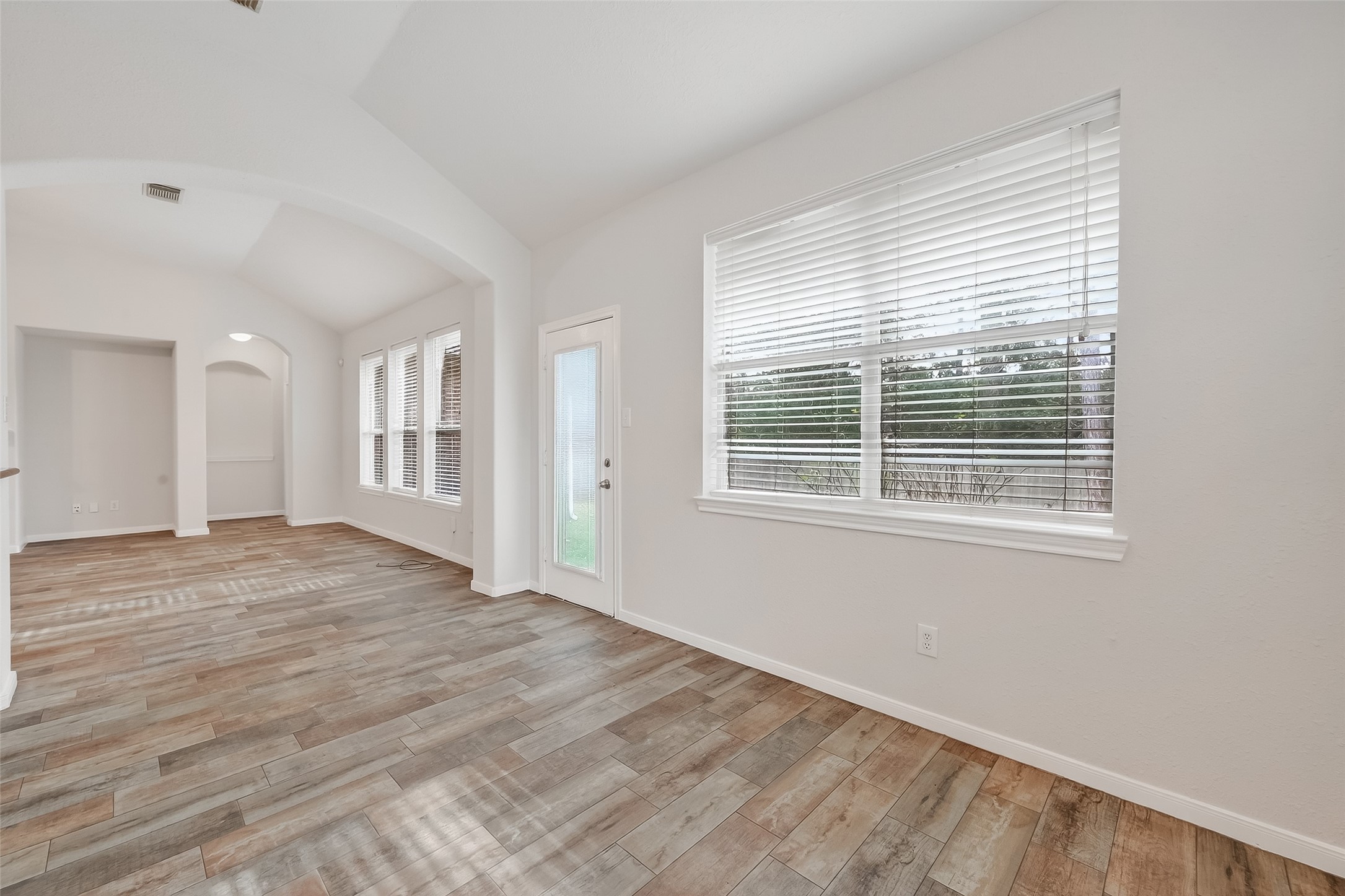 78 South Archwyck Circle Spring, TX 77382 - Photo 20 of 47 a view of an empty room with wooden floor and a window