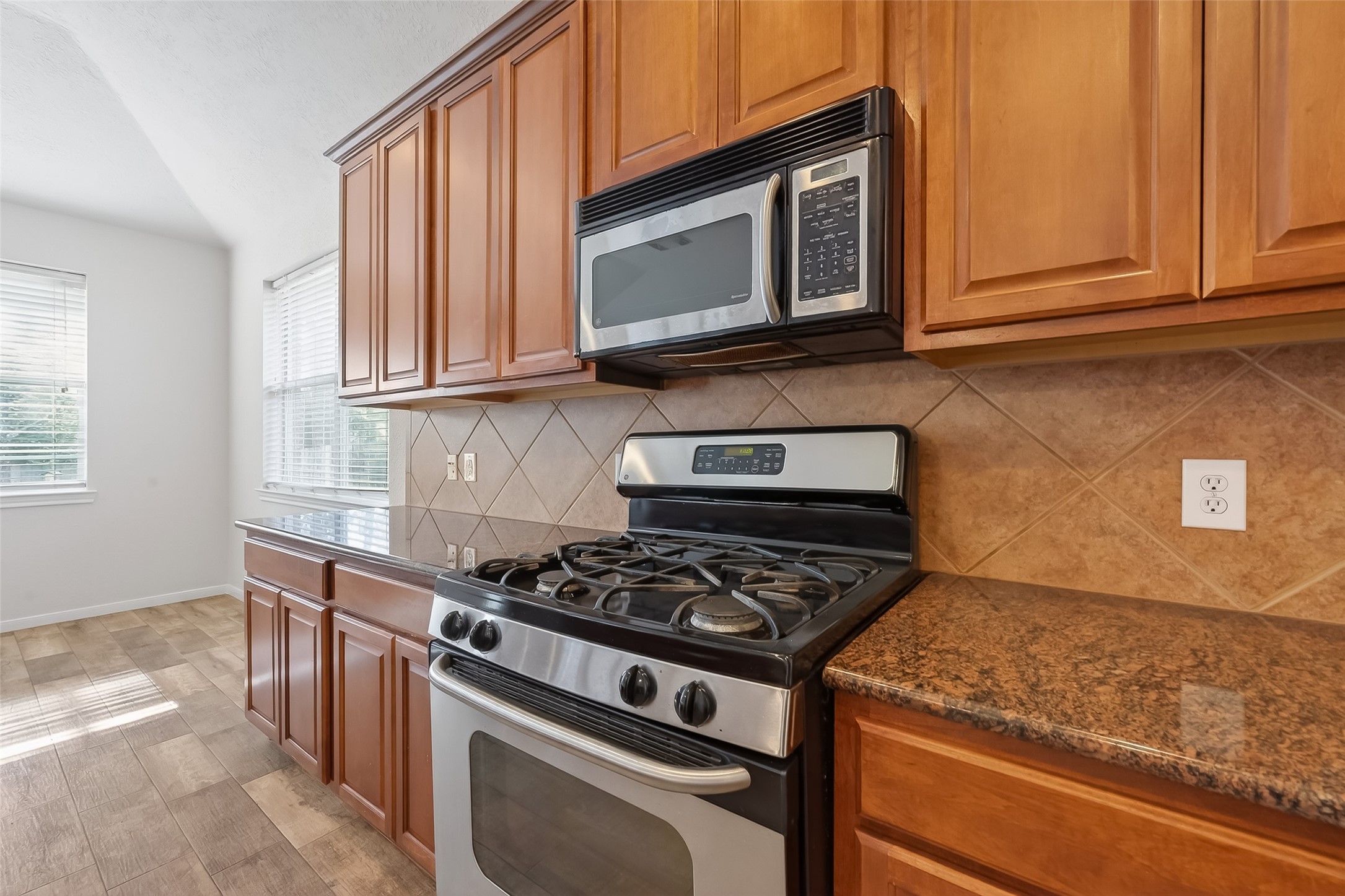 78 South Archwyck Circle Spring, TX 77382 - Photo 22 of 47 a kitchen with stainless steel appliances granite countertop white cabinets and a stove top oven
