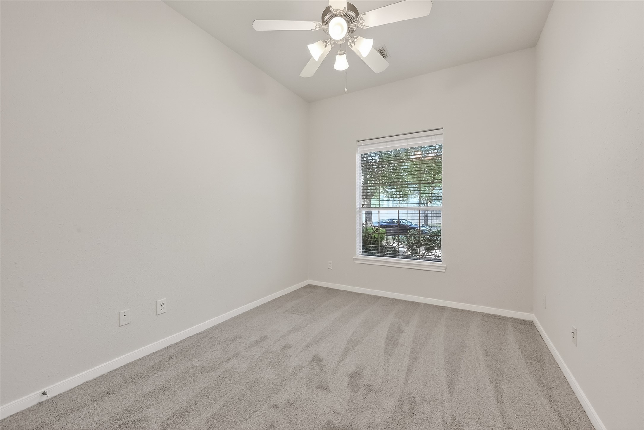 78 South Archwyck Circle Spring, TX 77382 - Photo 27 of 47 an empty room with a window and a fan