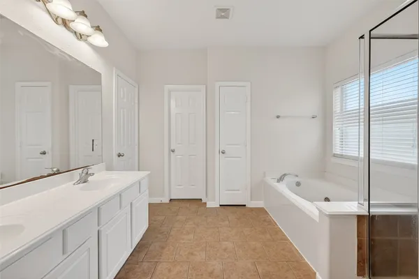 a bathroom with a double vanity sink and a mirror