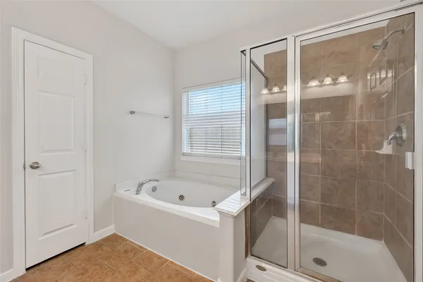 a bathroom with a tub and a shower