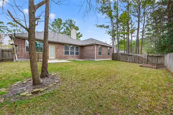 a front view of a house with a garden and yard