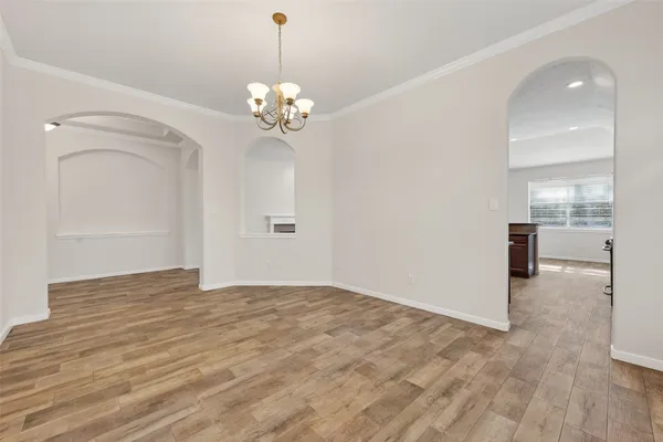 a view of an empty room with a chandelier