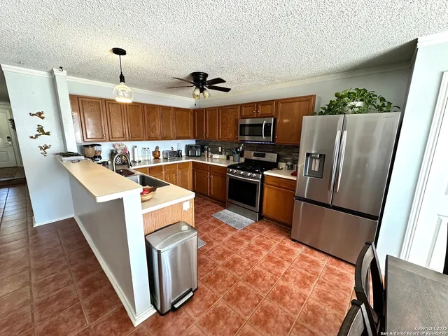 a kitchen with stainless steel appliances granite countertop a stove and a refrigerator