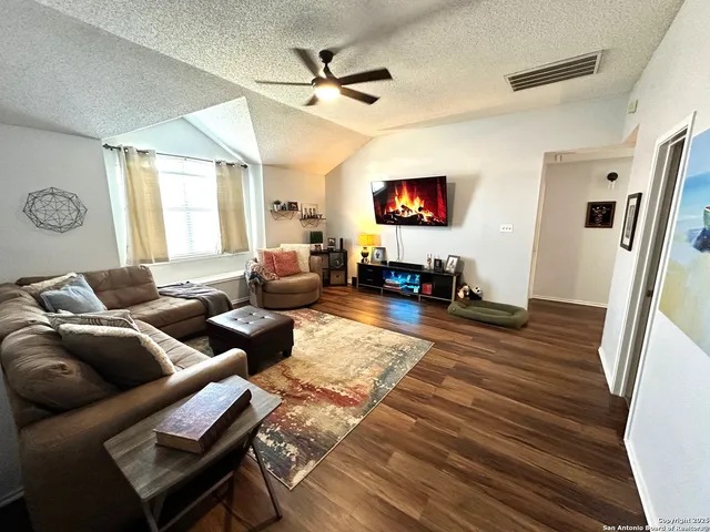 a bedroom with bed and wooden floor