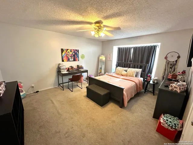 a bedroom with furniture and a flat screen tv