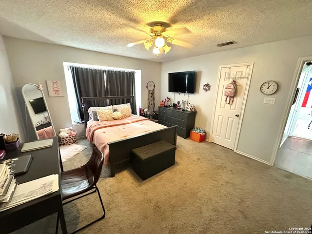 a bedroom with two beds and a window