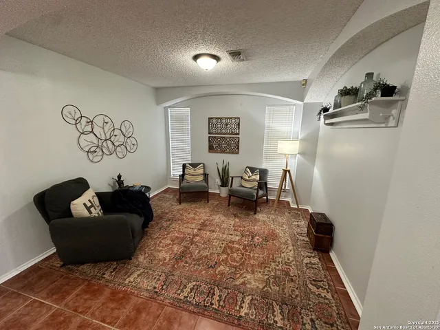 a living room with furniture rug and window