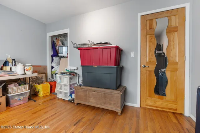 a bedroom with furniture and a wooden floor