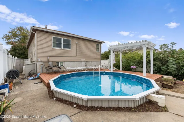 a view of a house with swimming pool and sitting area