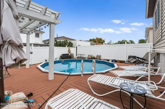 a view of a swimming pool with lounge chairs