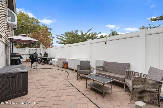 a view of a patio with dining table and chairs with a fire pit