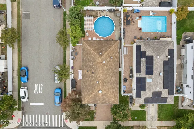 an aerial view of a house with a backyard