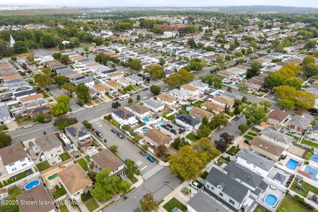 an aerial view of residential houses with outdoor space
